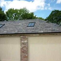 226 - Double garage doors in a boarded style in a cream spray finish