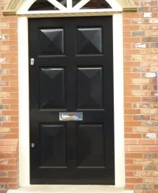 222 - Six specialist fielded panelled door spray finished in gloss black with a contrasting sunrise and frame in cream