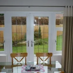 257 - French doors with leaded glass and sidelights which are opening casements