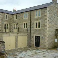 154 - Elevation view of property showing double garage doors, front door in a contrast colour to the windows and cottage bar windows and doors throughout the rest of the property