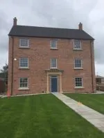 077 - Front elevation of property showing sash windows and entrance door