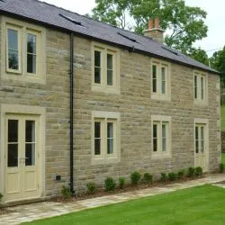 Side elevation showing cottage bar style windows and doors. Windows are top hung.