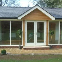 251 - Feature entrance doors spray finished in white leading into a summer house