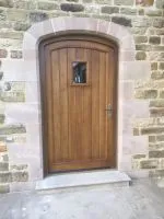 366 - Arched boarded door with glazed unit