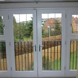 259 - French doors with leaded glass and sidelights spray finished in white