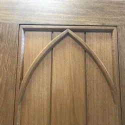088 - Close up of gothic arch on the boarded, segmented gates