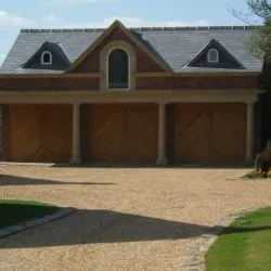228 - Triple garage doors with shevron boarding and a light oak top coat