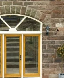288 - Feature entrance door with wide sidelights and clear glass and dentil moulding. Two tone spray finish to show a contrast between the doors and frame