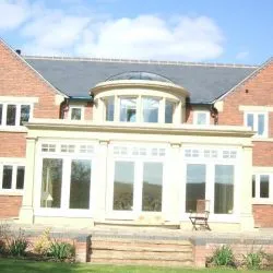 096 - Conservatory with a curved dome on the roof, spray finished in cream