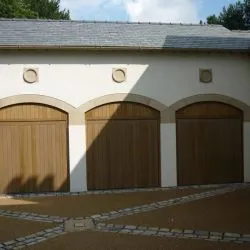 225 - Triple garage arched top doors with an antique bronze spray finish; fully automated by Lymewood