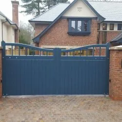 Boarded style gate with bar detailing and curved top - spray finished in a contemporary blue / grey colour