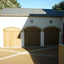 227 - Triple garage arched top doors with an antique bronze spray finish
