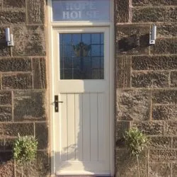 080 - Front door with etched glass top light, leaded glazed unit and boarded base
