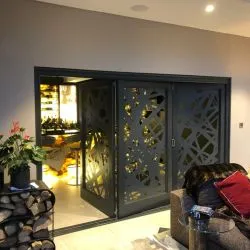 Stunning internal Bifold door with laser cut metal instead of glass