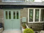 187 - Double doors in a slate green colour combining slim glazed units and boarded base