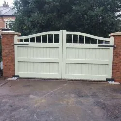 Curved top gate with a boarded and bar design - view from the driveway