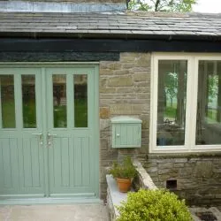 234 - Double doors in a slate green colour combining slim glazed units and boarded base