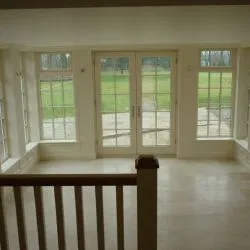 256 - Interior view of orangery showing French doors overlooking the garden